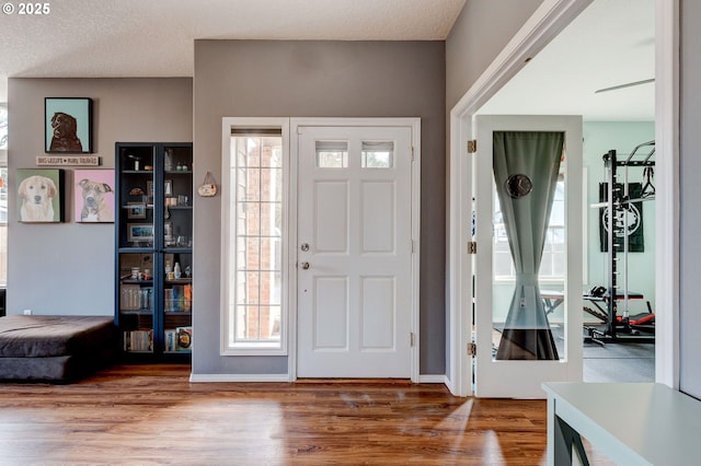 entryway featuring wood-type flooring and a textured ceiling