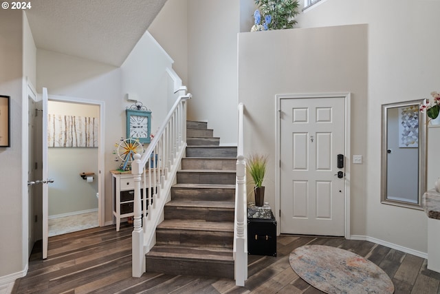 entrance foyer featuring dark hardwood / wood-style flooring and a textured ceiling