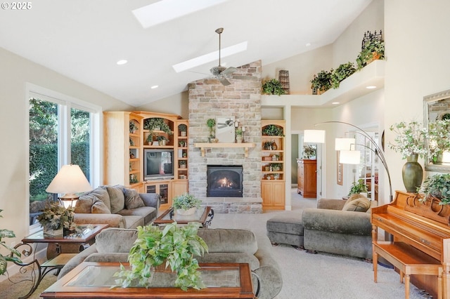 5632 Mac Way, Silverton, OR 97381 - living area featuring a skylight, carpet floors, high vaulted ceiling, a fireplace, and a ceiling fan