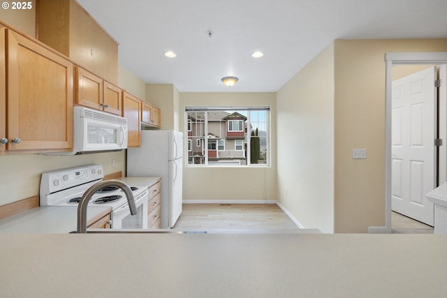 kitchen with recessed lighting, white appliances, light countertops, and baseboards