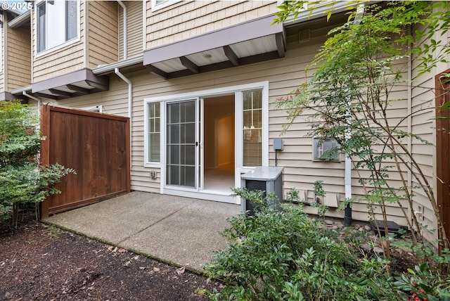 doorway to property featuring a patio area and fence