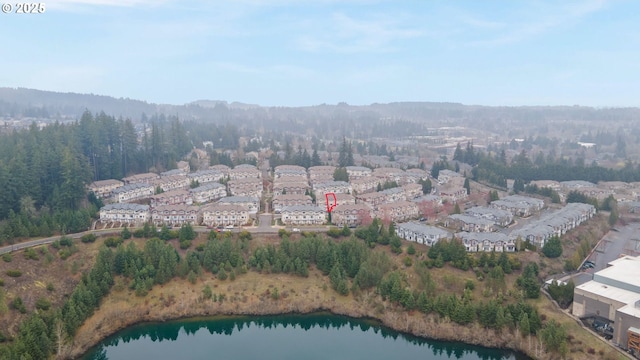 birds eye view of property with a forest view and a water view