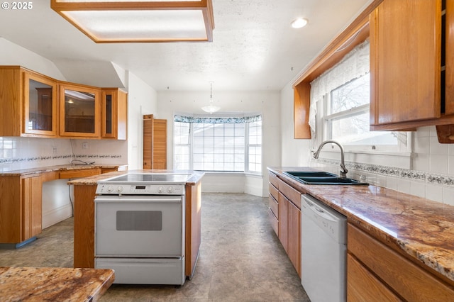 kitchen with sink, backsplash, white appliances, and decorative light fixtures