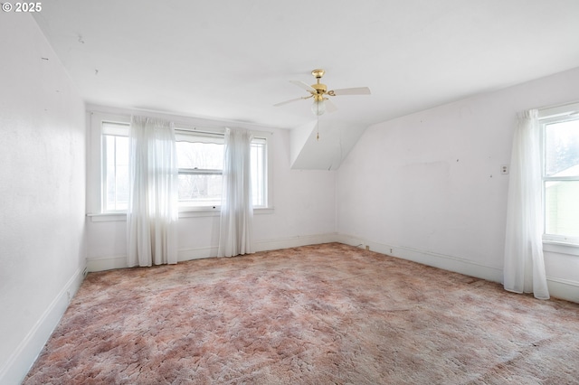 bonus room with ceiling fan, lofted ceiling, and light carpet