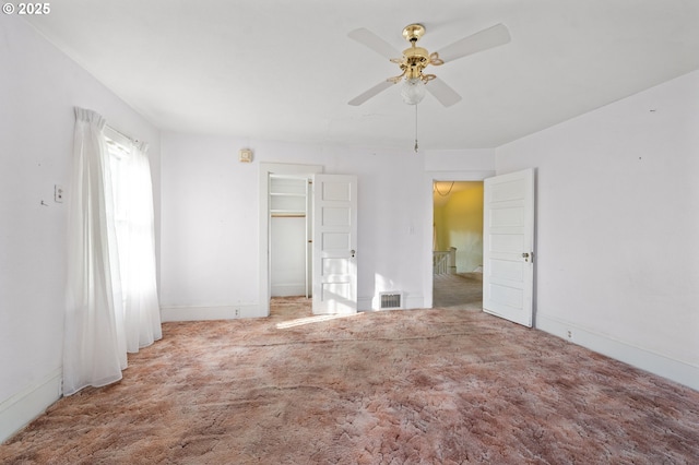 unfurnished bedroom with ceiling fan and carpet flooring