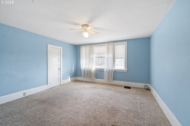 empty room featuring ceiling fan and carpet floors