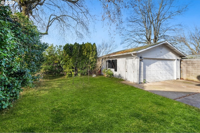 view of yard featuring a garage and an outbuilding