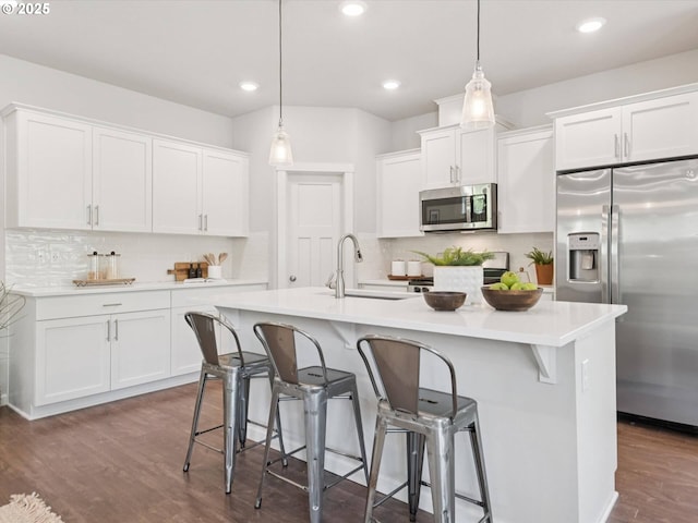 11179 SE Honorable Way, Happy Valley, OR 97086 - kitchen featuring stainless steel appliances, tasteful backsplash, white cabinetry, and recessed lighting