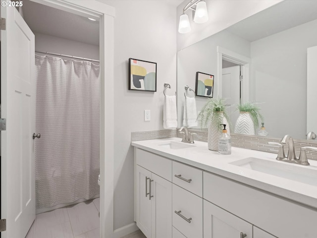 11179 SE Honorable Way, Happy Valley, OR 97086 - bathroom featuring double vanity, curtained shower, decorative backsplash, and marble look tiles