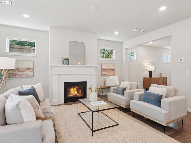 11179 SE Honorable Way, Happy Valley, OR 97086 - living area featuring wood finished floors, recessed lighting, and a glass covered fireplace