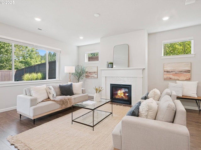 11179 SE Honorable Way, Happy Valley, OR 97086 - living area featuring wood finished floors, a glass covered fireplace, and recessed lighting