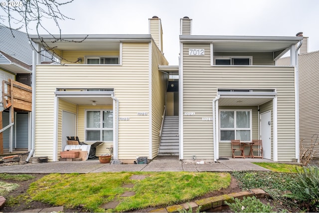 rear view of property featuring a patio area