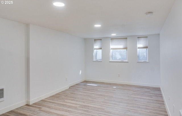 basement featuring recessed lighting, light wood-style flooring, and baseboards