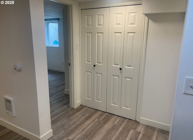 interior space featuring baseboards, light wood finished floors, and visible vents