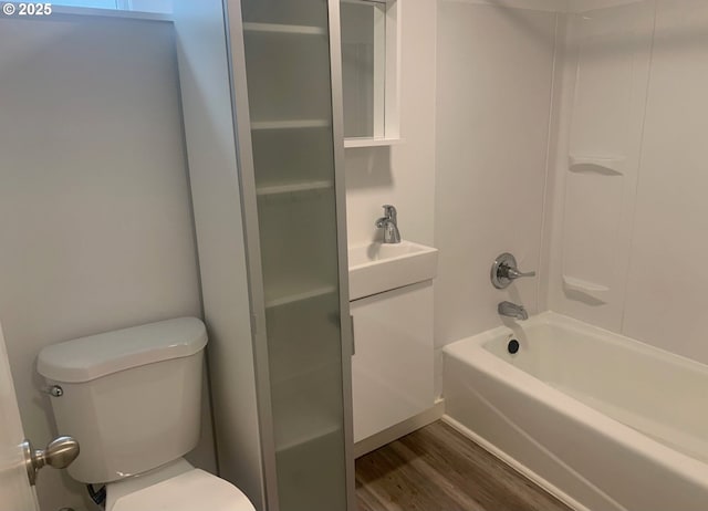 full bath featuring vanity, bathtub / shower combination, toilet, and wood finished floors
