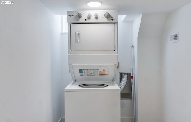 laundry room with laundry area, visible vents, and stacked washer and clothes dryer