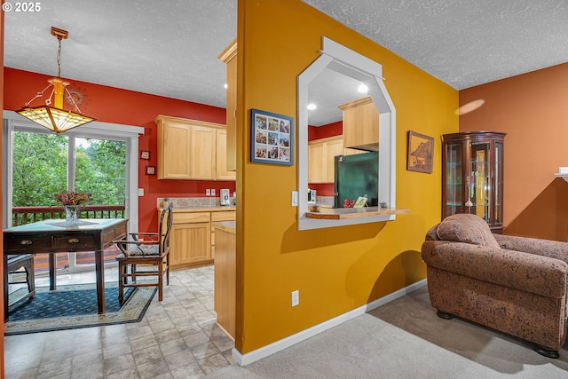 1259 SE Stapleton Loop, Gresham, OR 97080 - kitchen featuring freestanding refrigerator, a textured ceiling, light brown cabinetry, baseboards, and light countertops