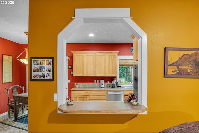 1259 SE Stapleton Loop, Gresham, OR 97080 - kitchen with dishwasher, light brown cabinets, a textured ceiling, and baseboards