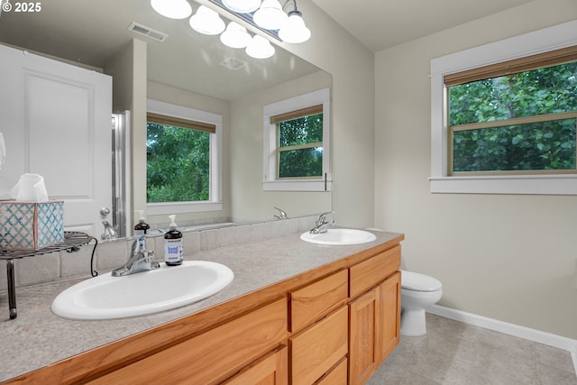 1259 SE Stapleton Loop, Gresham, OR 97080 - bathroom with healthy amount of natural light, double vanity, toilet, and baseboards
