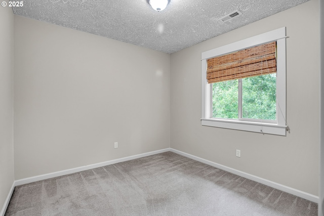 1259 SE Stapleton Loop, Gresham, OR 97080 - empty room featuring a textured ceiling, baseboards, and carpet floors