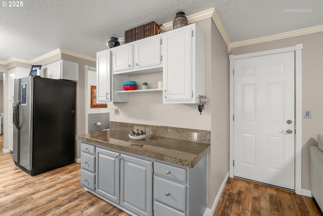 7100 SW 164th Ter, Beaverton, OR 97007 - kitchen with freestanding refrigerator, gray cabinets, light wood-style floors, white cabinetry, and open shelves