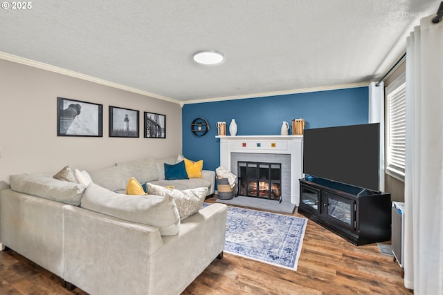 7100 SW 164th Ter, Beaverton, OR 97007 - living room with ornamental molding, a textured ceiling, wood finished floors, and a fireplace