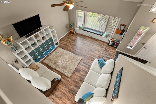 7100 SW 164th Ter, Beaverton, OR 97007 - living area with wood finished floors, a ceiling fan, and baseboards