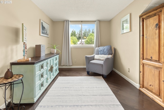 7100 SW 164th Ter, Beaverton, OR 97007 - living area with baseboards, dark wood-style floors, and a textured ceiling