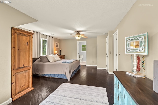 7100 SW 164th Ter, Beaverton, OR 97007 - bedroom with dark wood-style floors, connected bathroom, baseboards, and a ceiling fan