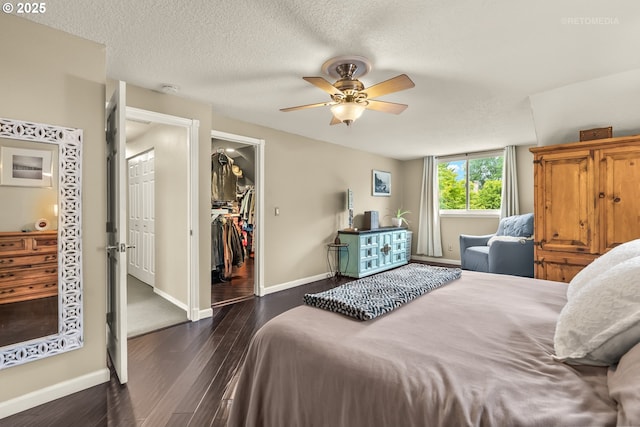 7100 SW 164th Ter, Beaverton, OR 97007 - bedroom featuring baseboards, wood finished floors, a spacious closet, a ceiling fan, and a closet