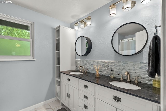 7100 SW 164th Ter, Beaverton, OR 97007 - full bathroom featuring double vanity, backsplash, baseboards, and marble finish floors