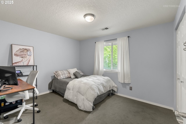 7100 SW 164th Ter, Beaverton, OR 97007 - bedroom with an office area, dark colored carpet, a textured ceiling, baseboards, and a closet