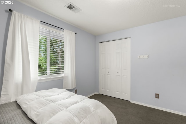 7100 SW 164th Ter, Beaverton, OR 97007 - bedroom featuring dark carpet, a closet, and baseboards