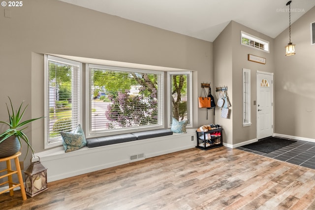 7100 SW 164th Ter, Beaverton, OR 97007 - entryway featuring wood finished floors, plenty of natural light, high vaulted ceiling, and baseboards