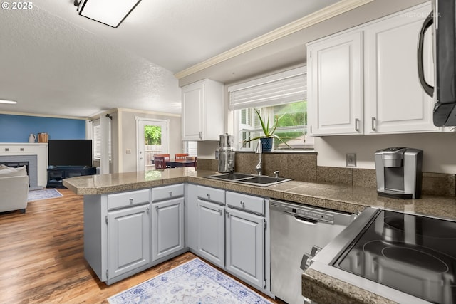 7100 SW 164th Ter, Beaverton, OR 97007 - kitchen with tile counters, dishwasher, a peninsula, a sink, and crown molding