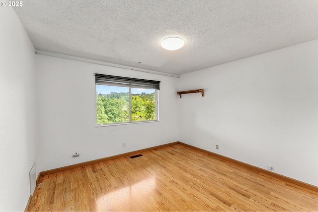 154 W Hickory St, Roseburg, OR 97471 - unfurnished room featuring light wood-style floors and a textured ceiling