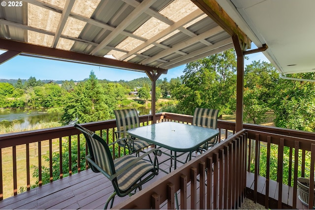 154 W Hickory St, Roseburg, OR 97471 - deck featuring outdoor dining space, a water view, and view of wooded area