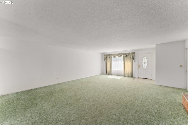 154 W Hickory St, Roseburg, OR 97471 - unfurnished living room with light colored carpet and a textured ceiling