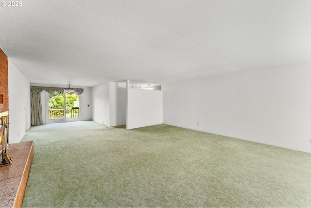 154 W Hickory St, Roseburg, OR 97471 - unfurnished living room featuring light colored carpet, a textured ceiling, a brick fireplace, and a chandelier