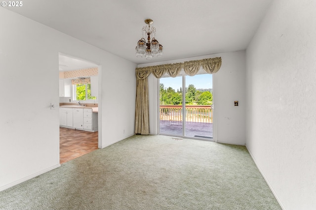 154 W Hickory St, Roseburg, OR 97471 - empty room featuring light colored carpet, a chandelier, and a water view