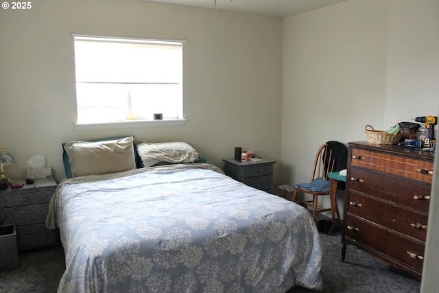 bedroom with dark colored carpet