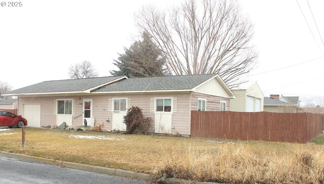 ranch-style home with a garage and a front yard