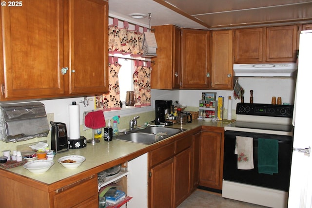 kitchen featuring under cabinet range hood, a sink, light countertops, electric range oven, and brown cabinetry