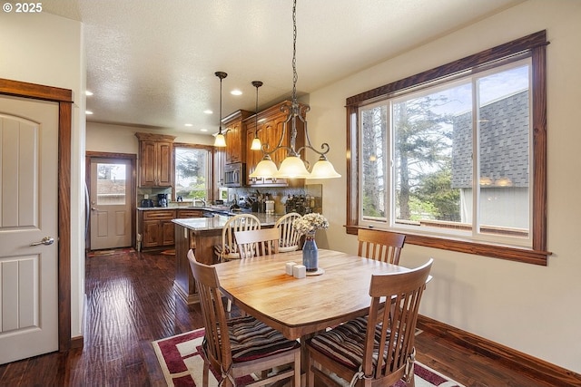 dining space with dark wood-style flooring, recessed lighting, and baseboards