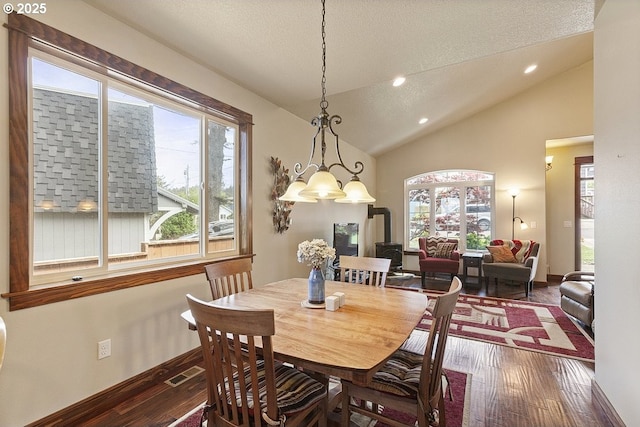 dining space featuring hardwood / wood-style flooring, vaulted ceiling, recessed lighting, baseboards, and a textured ceiling