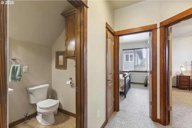 bathroom featuring toilet and baseboards