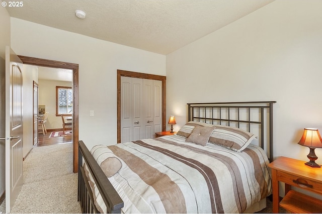 bedroom featuring light carpet and a closet