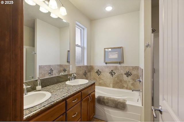 bathroom with a bath, double vanity, and a shower