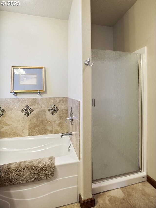 full bathroom featuring a shower stall and a bath