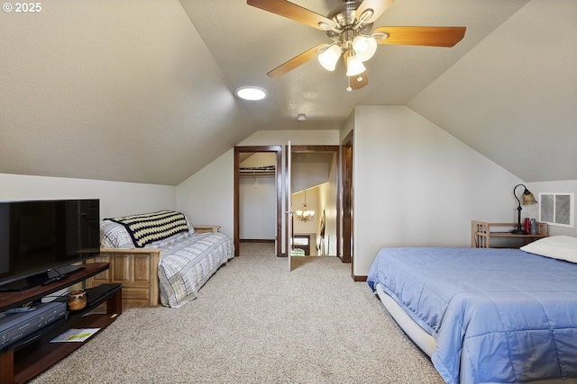 bedroom featuring lofted ceiling, carpet, a textured ceiling, a ceiling fan, and baseboards